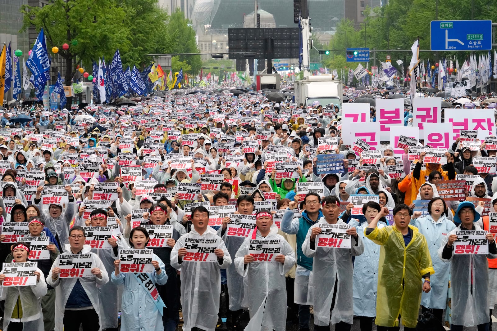 Members of the Korean Confederation of Trade Unions gather to attend a rally on May Day in Seoul, South Korea, Thursday, May 1, 2025. The letters read "Let's win basic labor rights." (AP Photo/Ahn Young-joon)
