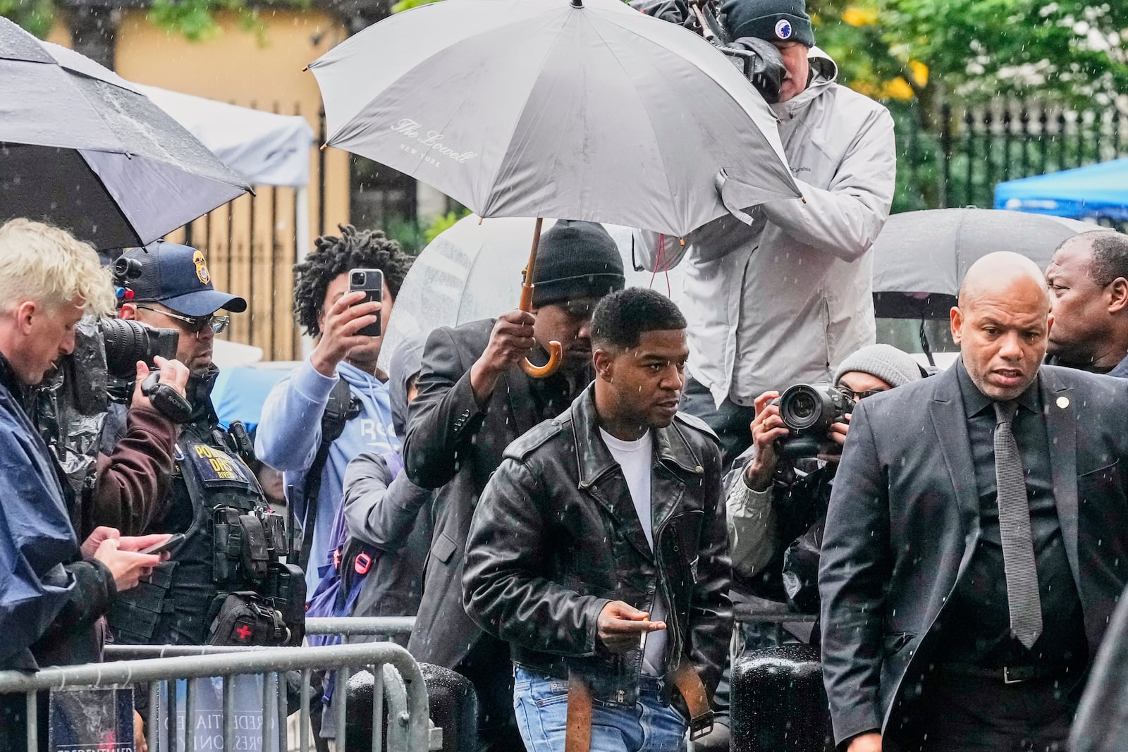 Rapper Kid Cudi, center, arrives at Federal Court for the trial of Sean "Diddy" Combs, in New York, Thursday, May 22, 2025. (AP Photo/Richard Drew)