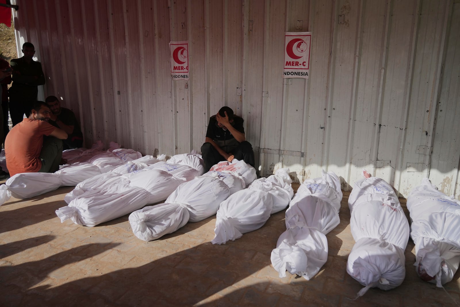 Palestinians mourn their relatives killed in an Israeli airstrikes in Jabalia, northern Gaza Strip, on Wednesday, May 14, 2025. According to local hospitals, 48 people were killed in the strikes, including 22 children. (AP Photo/Jehad Alshrafi)