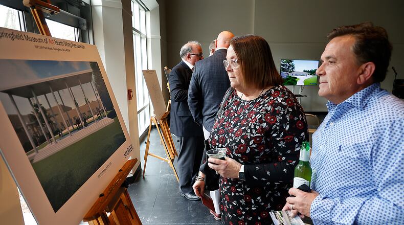 Alicia and Greg Hupp look over the artist's renderings showing what the renovated North Wing of the Springfield Museum of Art will look like following a ribbon cutting ceremony and reception celebrating the start of the multi-million dollar project Thursday, March 23, 2023. BILL LACKEY/STAFF