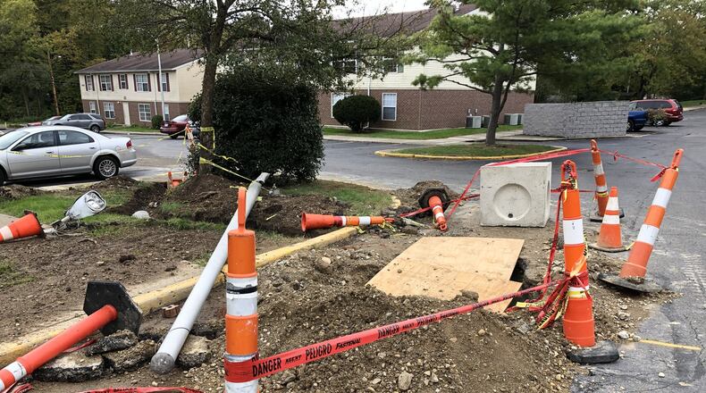 The utility pole and construction hole that the driver fell in while fleeing the scene in Ronez Apartments. BILL LACKEY/STAFF
