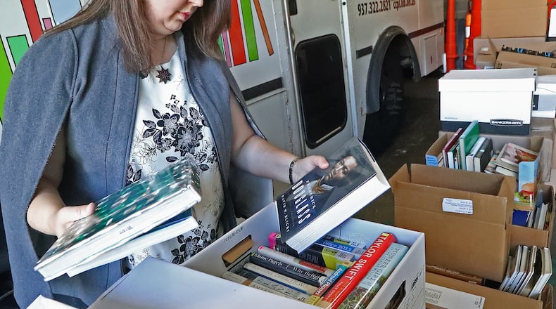 Allison Peck sorts through boxes of books Tuesday, Oct. 4, 2022 for the Friends of the Clark County Library's book sale. The annual event happens again this weekend. BILL LACKEY/STAFF