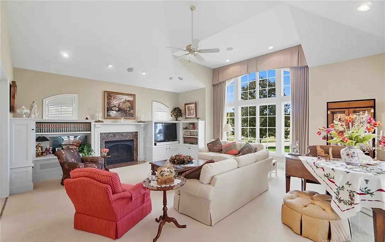 The living room has a vaulted ceiling, neutral carpeting, a built in entertainment center, gas fireplace and bult in bookcases. CONTRIBUTED