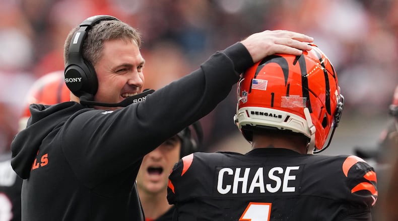 Cincinnati Bengals head coach Zac Taylor celebrates with wide receiver Ja'Marr Chase (1) after a touchdown during the first half of an NFL football game Sunday, Dec. 28, 2025, in Cincinnati. (AP Photo/Jeff Dean)