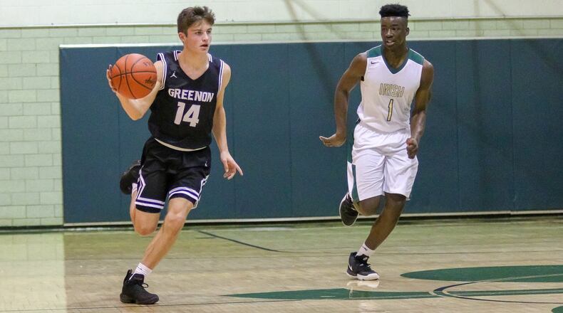 Greenon High School’s Clayton Minteer is guarded by Catholic Central’s Mykah Eichie during their game on Tuesday night at Jason Collier Gymnasium in Springfield. Eichie had a career-high 22 points as the Irish won 73-43. CONTRIBUTED PHOTO BY MICHAEL COOPER