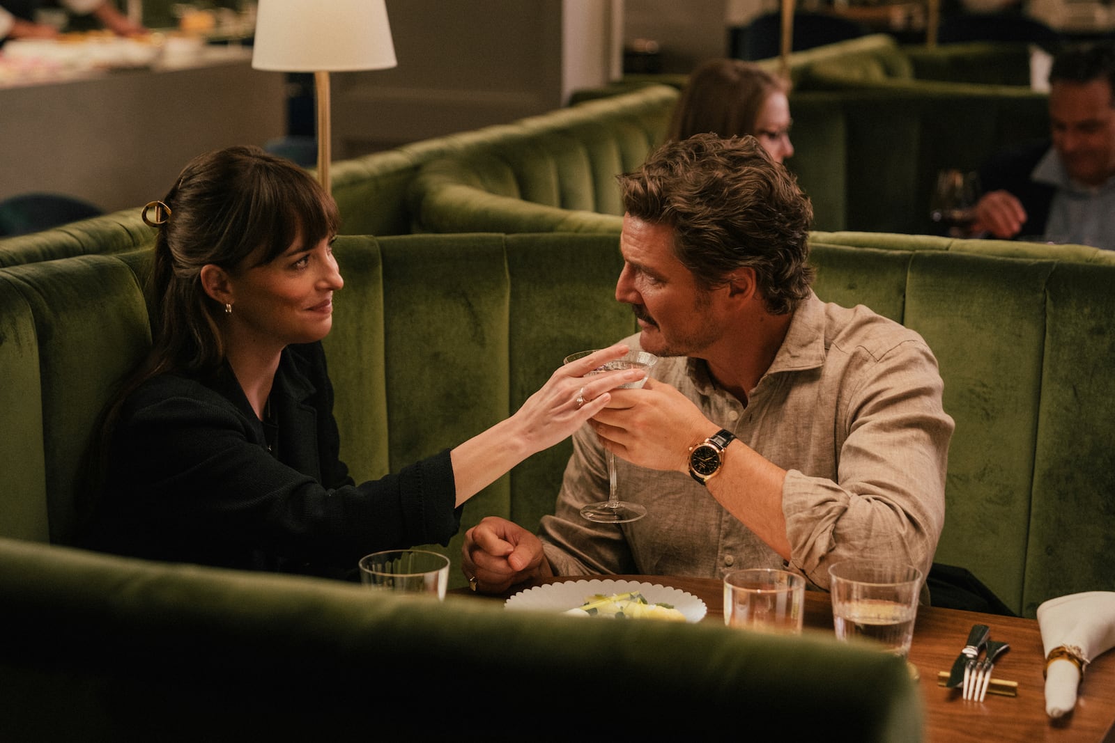 This image released by A24 shows Dakota Johnson, left, and Pedro Pascal in a scene from "Materialists." (A24 via AP)