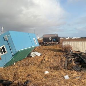 An unoccupied home rests on it's roof after being knocked over in Kotlik, Alaska, Sunday, Oct. 12, 2025, after the remnants of Typhoon Halong hit western Alaska. (AP Photo/Adaline Pete)