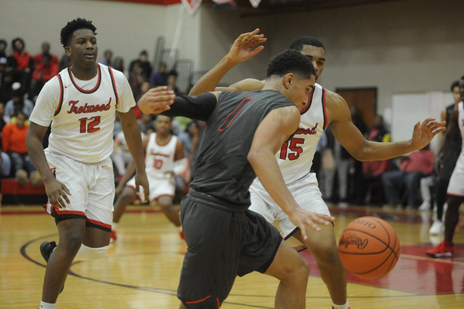 Wayne’s Deshon Parker (with ball) is checked by Trotwood’s Malachi Mathews (12) and Justin Stephens. Wayne defeated host Trotwood-Madison 90-87 in double-OT in a boys high school basketball game on Friday, Dec. 29, 2017. MARC PENDLETON / STAFF
