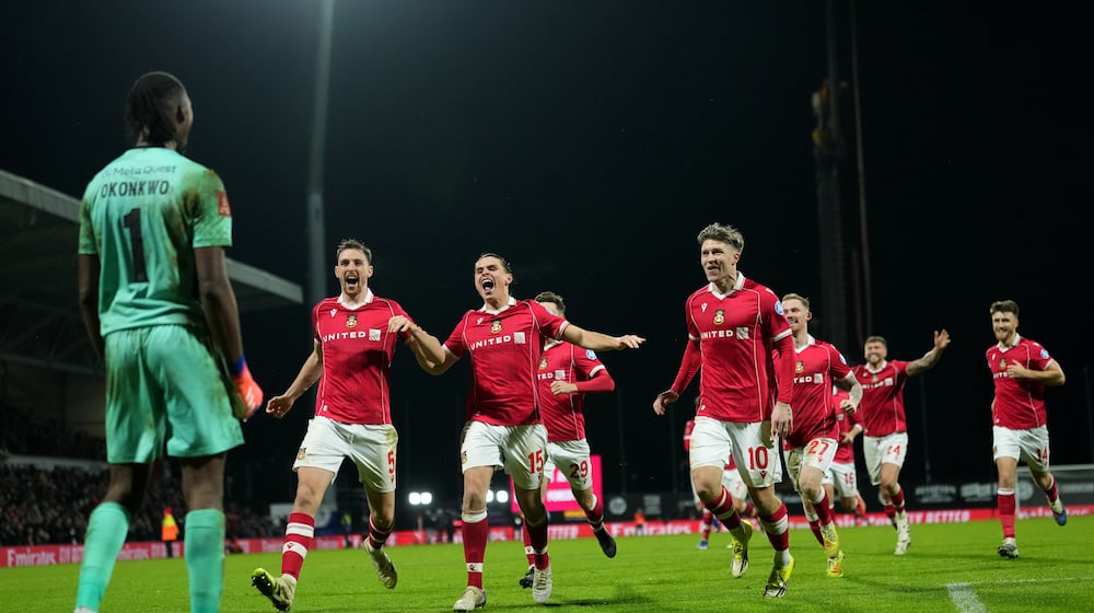 FILE - Wrexham's goalkeeper Arthur Okonkwo, left, celebrates with teammates after a penalty shootout at the end of the English FA Cup third round soccer match between Wrexham and Nottingham Forest in Wrexham, Wales, Friday, Jan. 9, 2026. (AP Photo/Jon Super, File)