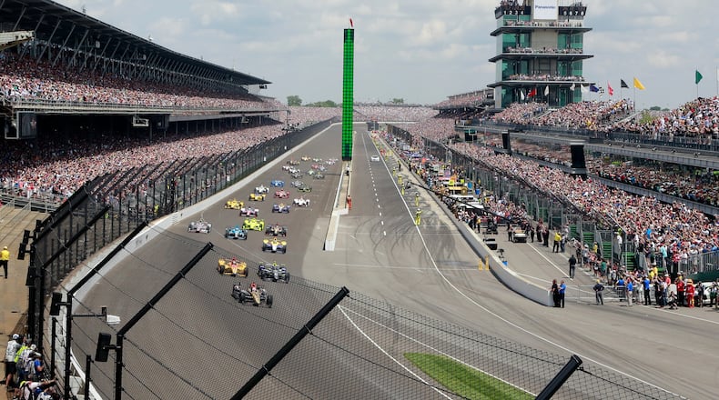 FILE - In this May 29, 2016, file photo, James Hinchcliffe, of Canada, leads the field into the first turn on the start of the 100th running of the Indianapolis 500 auto race at Indianapolis Motor Speedway in Indianapolis. Indianapolis Motor Speedway president Doug Boles had a very real fear following last year’s 100th edition of the Indy 500: That many in the record-setting crowd packing his track last May would decide to be “101 and done.” Instead, the milestone appears to have given the Greatest Spectacle in Racing a lasting bump heading into next weekend’s running. (AP Photo/R Brent Smith, File)