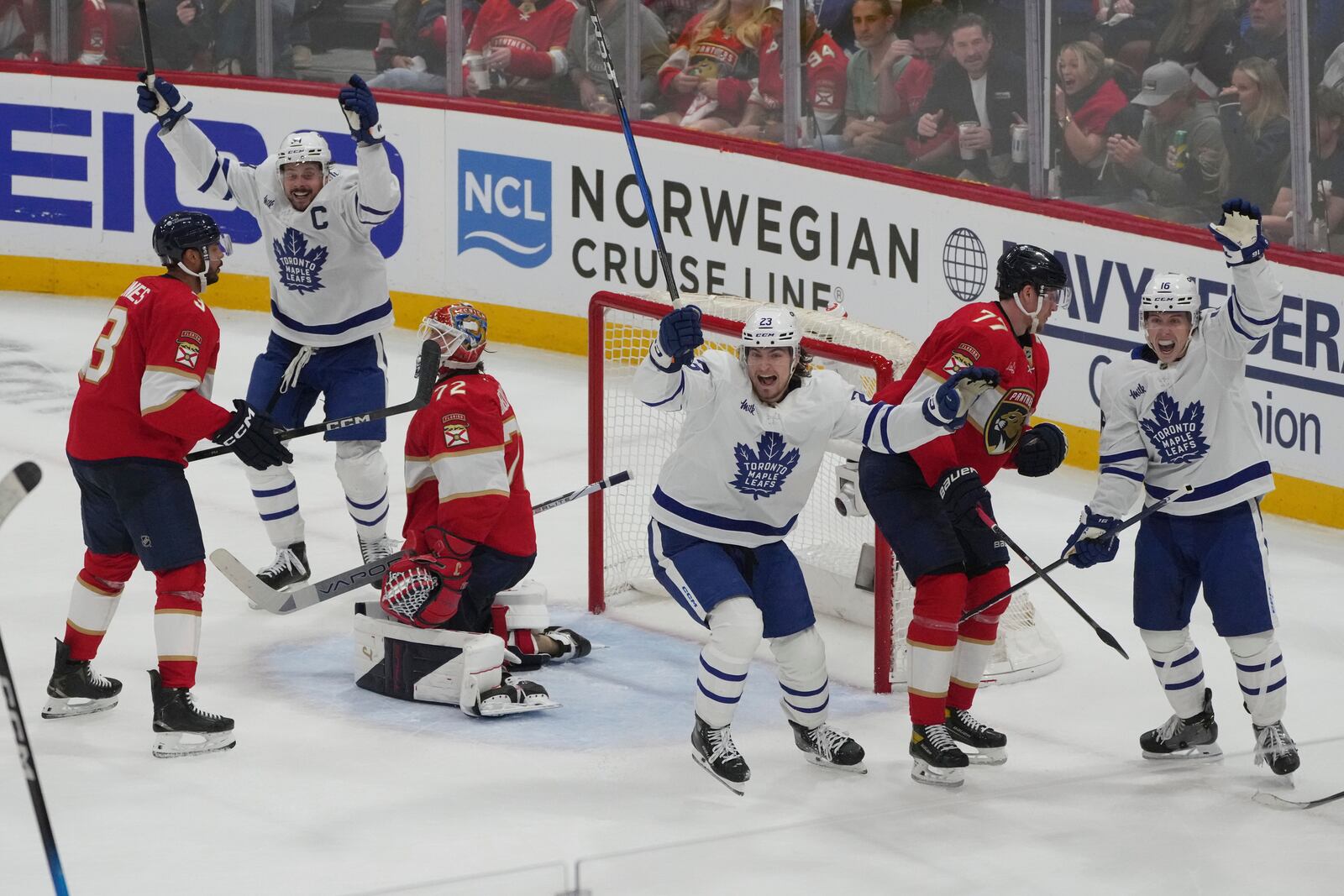 Toronto Maple Leafs players celebrate a goal by defenseman Morgan Rielly during the third period in Game 3 of a second-round NHL hockey playoff series against the Florida Panthers, Friday, May 9, 2025, in Sunrise, Fla. (AP Photo/Marta Lavandier)