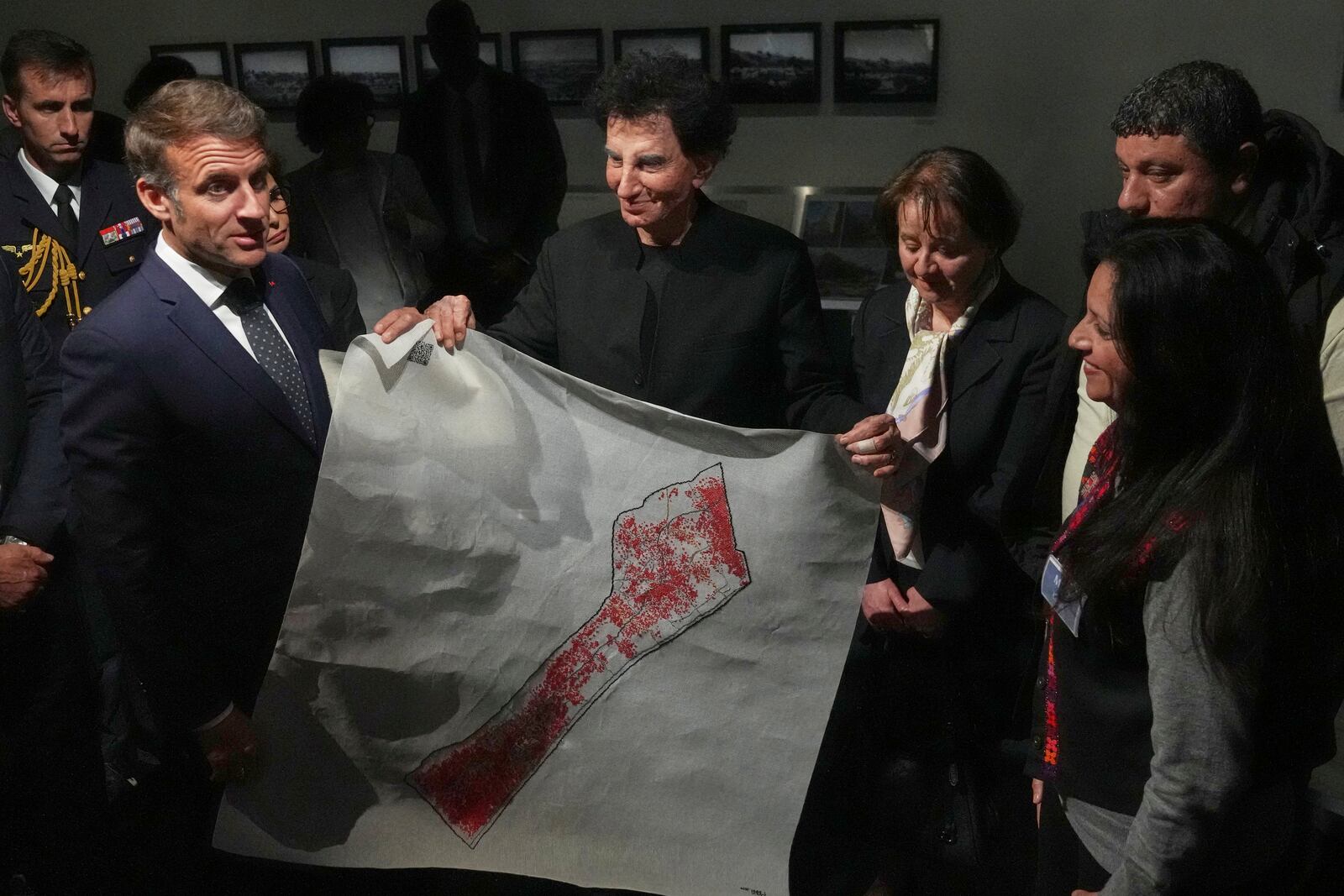 French President Emmanuel Macron, left, and IMA director Jack Lang, center, hold a map of Palestine as they visit the exhibition "Treasures rescued from Gaza" Monday, April 14, 2025 at the Arab World Institute (IMA) in Paris. (AP Photo/Michel Euler, Pool)