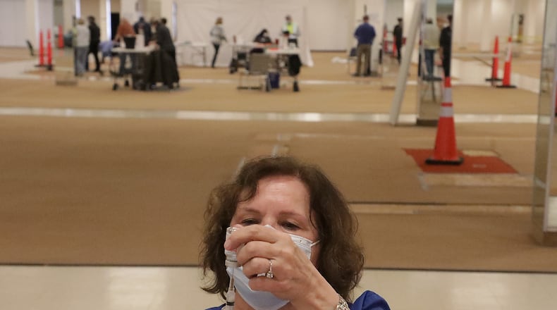Jennie Router loads a syringe with the COVID vaccine Tuesday at the Clark County vaccine distribution center. BILL LACKEY/STAFF