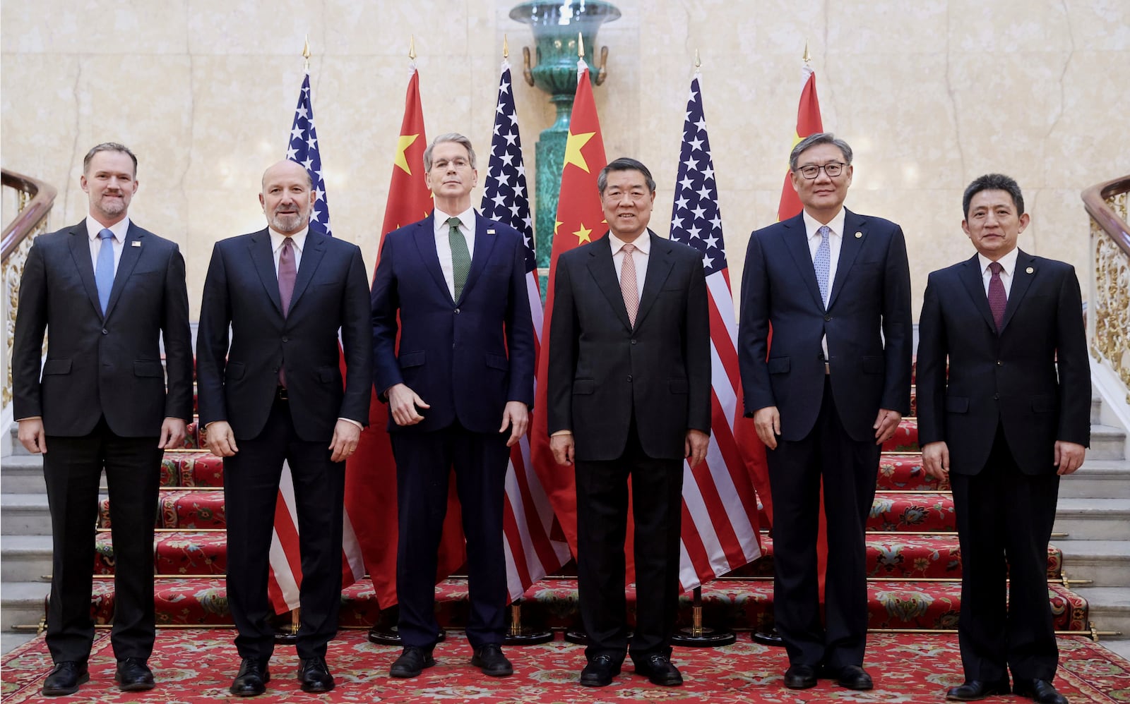 In this photo released by Xinhua News Agency, Chinese Vice Premier He Lifeng, center right, and U.S. Treasury Secretary Scott Bessent, center left, pose for a group photo with delegations before their meeting to discuss China-U.S. trade, in London, Monday, June 9, 2025. (Li Ying/Xinhua via AP)