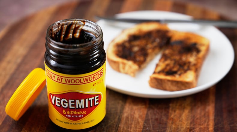 A piece of toast is prepared with Vegemite in Sydney, Australia, Monday, Nov. 17, 2025. (AP Photo/Rick Rycroft)