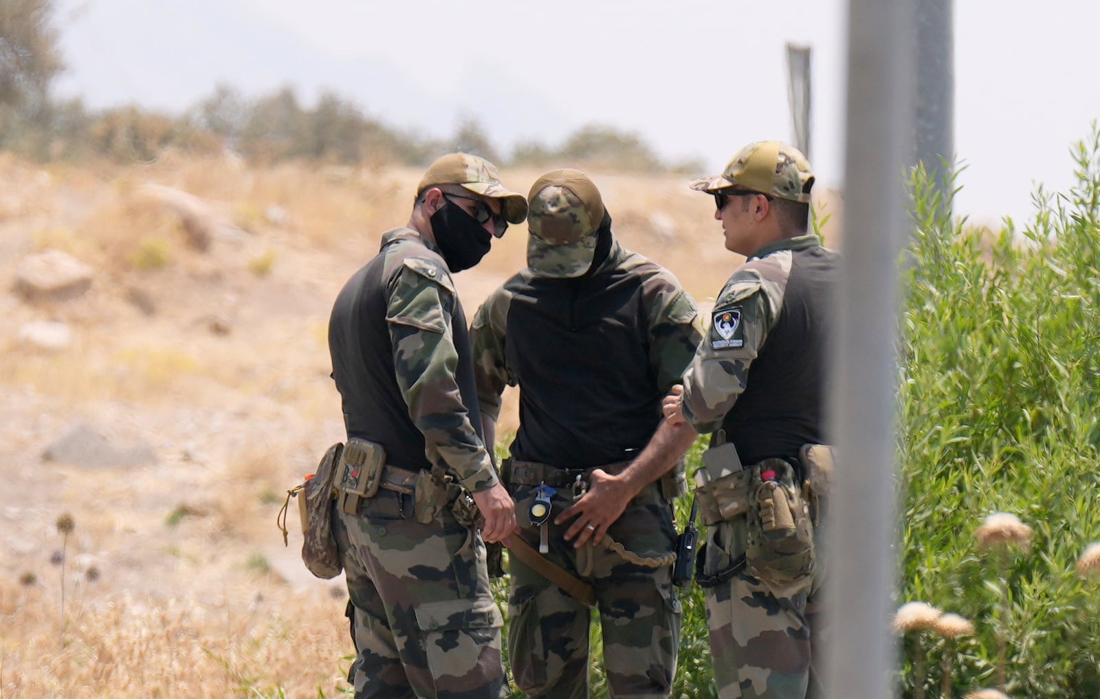 Forces of the regional Kurdish administration secure the area of the Jasana Cave ahead of a symbolic disarmament ceremony by the separatist PKK group as part of the peace process with Turkey, in Sulaymaniyah governorate, Iraq, Friday, July 11, 2025. (AP Photo/Hadi Mizban)