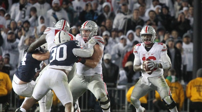 Ohio State’s J.T. Barrett looks for running room before being sacked on Ohio State’s last drive against Penn State on Saturday, Oct. 22, 2016, at Beaver Stadium in State College, Pa. David Jablonski/Staff
