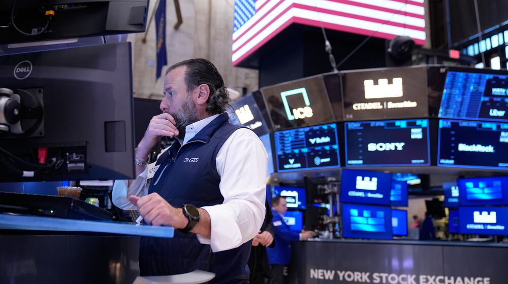 Michael Pistillo works on the floor at the New York Stock Exchange in New York, Tuesday, Nov. 11, 2025. (AP Photo/Seth Wenig)
