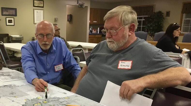 Clark County residents Andy Elder and John Blanton discuss areas they believe could be preserved or developed at Tuesday s Clark County Connect meeting at the South Vienna Government Center on Thursday as part of efforts to update the county s land use plan. MICHAEL COOPER/STAFF