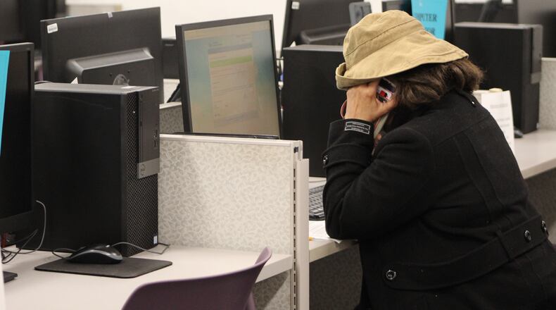A woman works at a computer at the Montgomery County Job Bank in this March 2020 file photo. The Job Bank allowed residents to use its computers to apply for unemployment benefits during the coronavirus crisis. CORNELIUS FROLIK / STAFF