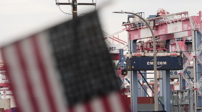 A U.S. flag files at the Port of Long Beach Friday, Feb. 20, 2026, in Long Beach, Calif. (AP Photo/Damian Dovarganes)