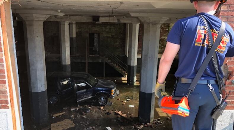 Crews responded to a call of a vehicle in the basement of the Crowell Collier Building in Springfield on Thursday, May 10, 2018. BILL LACKEY / STAFF