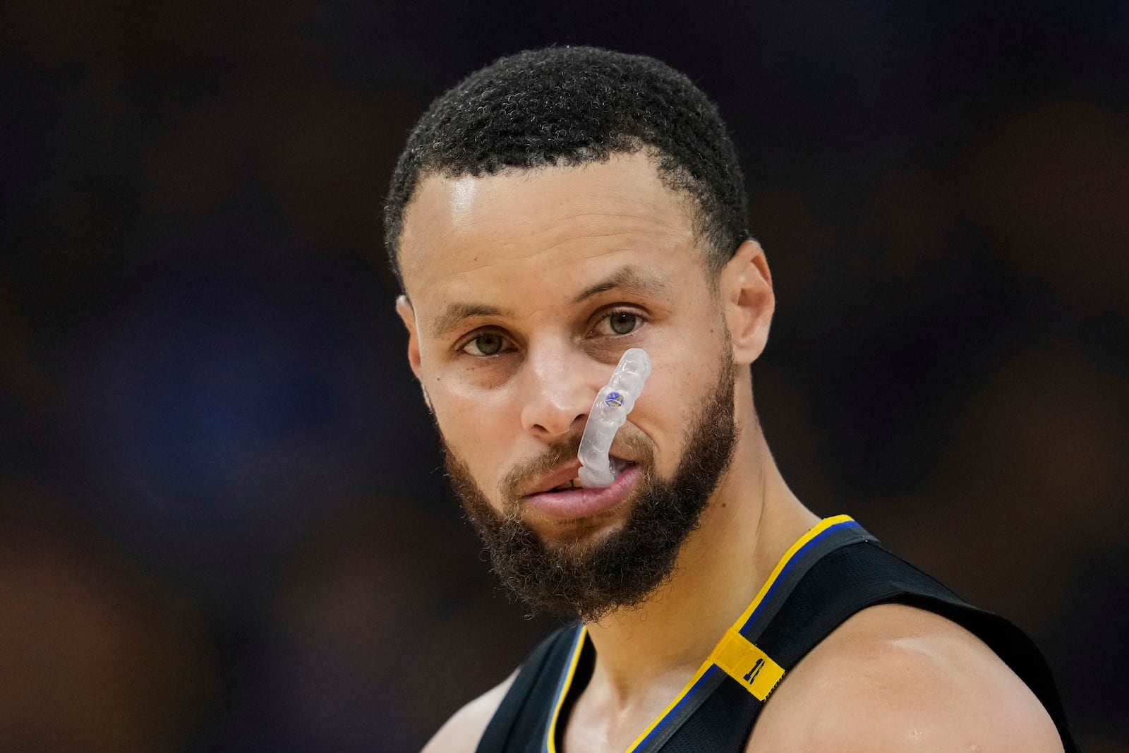 Golden State Warriors guard Stephen Curry looks to the Houston Rockets bench during the first half of Game 6 of an NBA basketball first-round playoff series Friday, May 2, 2025, in San Francisco. (AP Photo/Godofredo A. Vásquez)