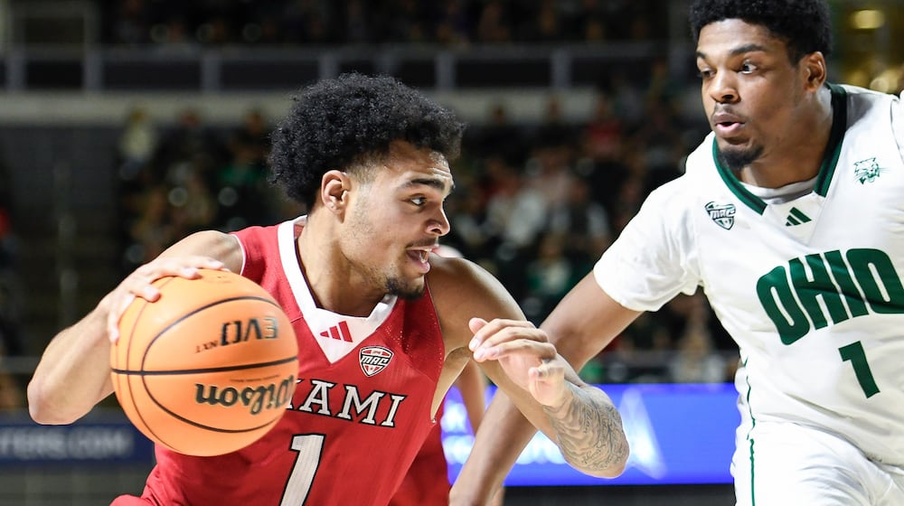 Miami (Ohio) guard Trey Perry (1) drives past Ohio forward Javan Simmons (1) during the first half of an NCAA college basketball game, Friday, March 6, 2026, in Athens, Ohio. (AP Photo/HG Biggs)