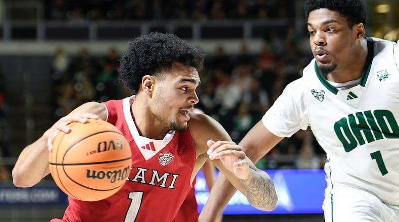 Miami (Ohio) guard Trey Perry (1) drives past Ohio forward Javan Simmons (1) during the first half of an NCAA college basketball game, Friday, March 6, 2026, in Athens, Ohio. (AP Photo/HG Biggs)