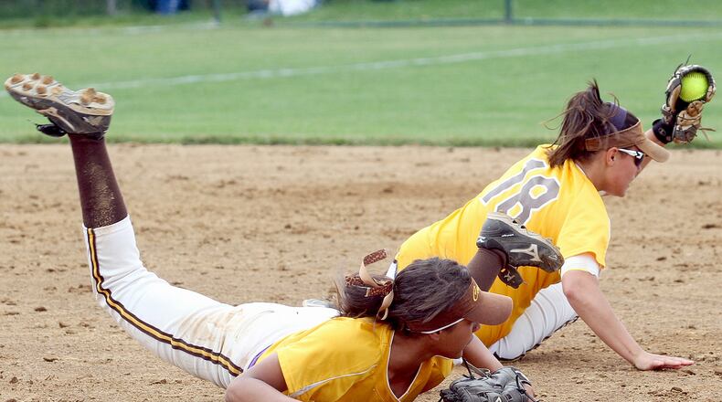 Kenton Ridge second baseman Monika Foster holds on to a Greenville ground ball after colliding with shortstop Mykee Holtz during their Div II regional softball final game at Mason Saturday, June 1, 2013. Foster was shaken up on the play but stayed in the game. CONTRIBUTED PHOTO BY E.L. HUBBARD