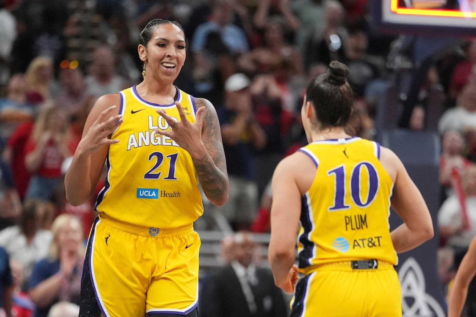 Los Angeles Sparks' Mercedes Russell (21) and Kelsey Plum react during the second half of a WNBA basketball game against the Indiana Fever, Saturday, July 5, 2025, in Indianapolis. (AP Photo/Michael Conroy)