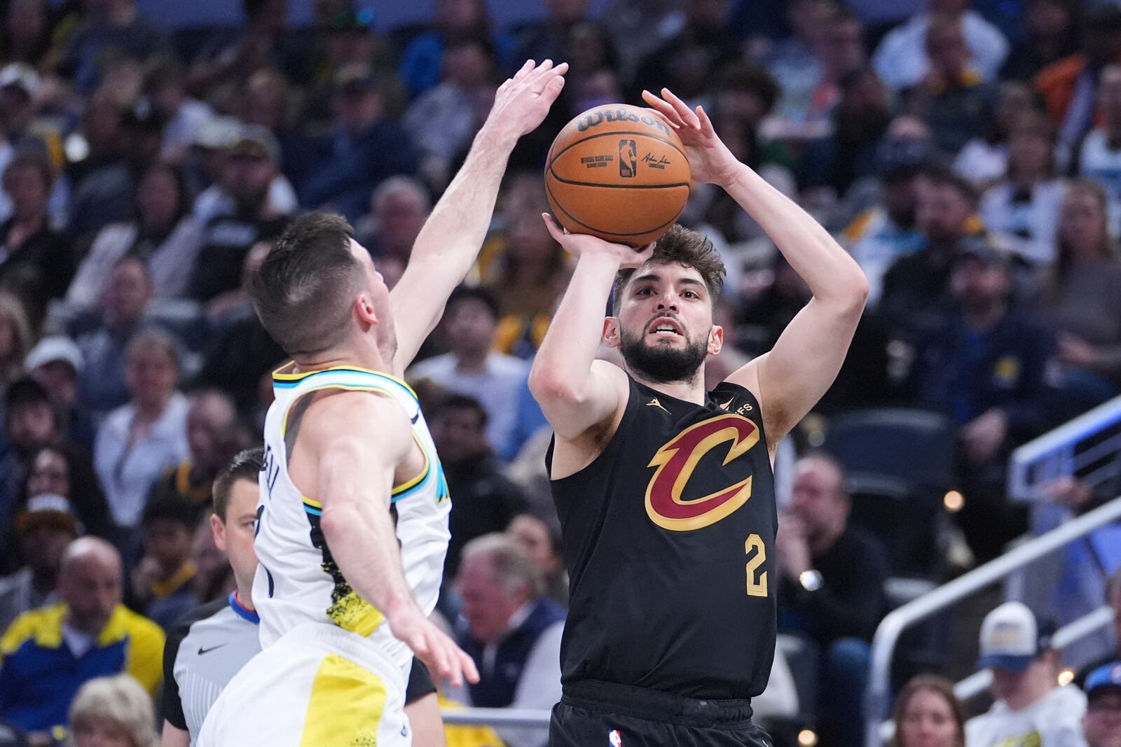 Cleveland Cavaliers guard Ty Jerome (2) shoots over Indiana Pacers guard T.J. McConnell (9) during the first half of an NBA basketball game in Indianapolis, Thursday, April 10, 2025. (AP Photo/Michael Conroy)