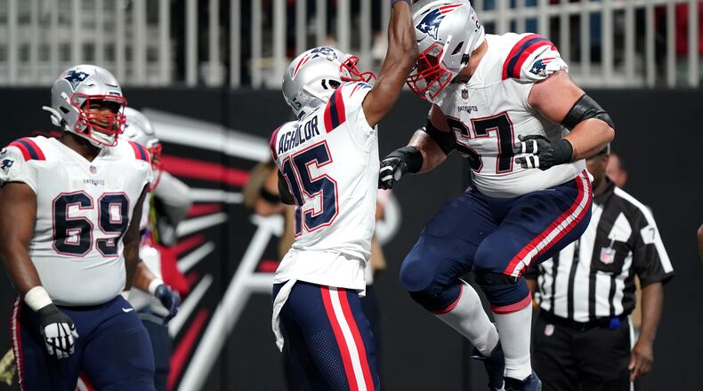 New England Patriots wide receiver Nelson Agholor (15) celebrates his touchdown with New England Patriots guard Ted Karras (67) during the first half of an NFL football game against the Atlanta Falcons, Thursday, Nov. 18, 2021, in Atlanta. (AP Photo/Brynn Anderson)