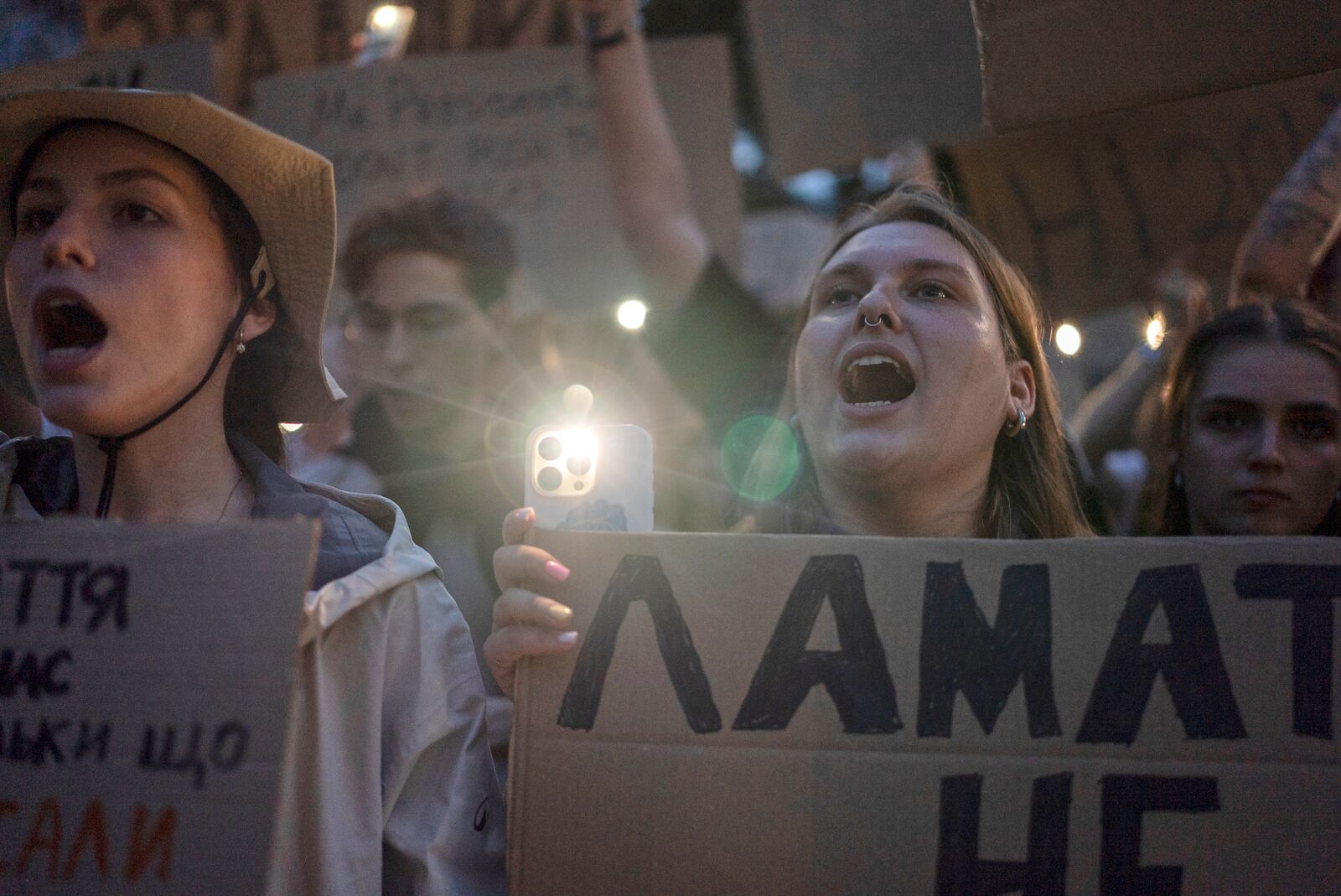 women chant while holding banners during a protest against a law targeting anti-corruption institutions in central Kyiv, Ukraine, Tuesday, July 22, 2025. (AP Photo/Alex Babenko)