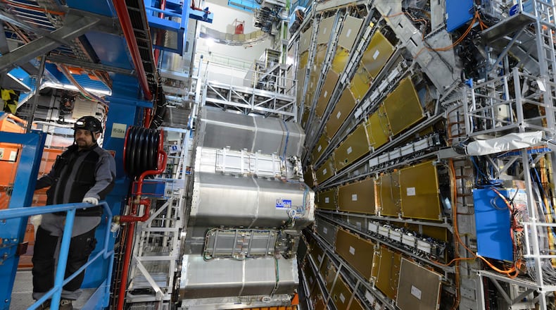FILE - A technician works in the LHC (Large Hadron Collider) tunnel of the European Organization for Nuclear Research, CERN, during a press visit in Meyrin, near Geneva, Switzerland, Feb. 16, 2016. (Laurent Gillieron/Keystone via AP, File)