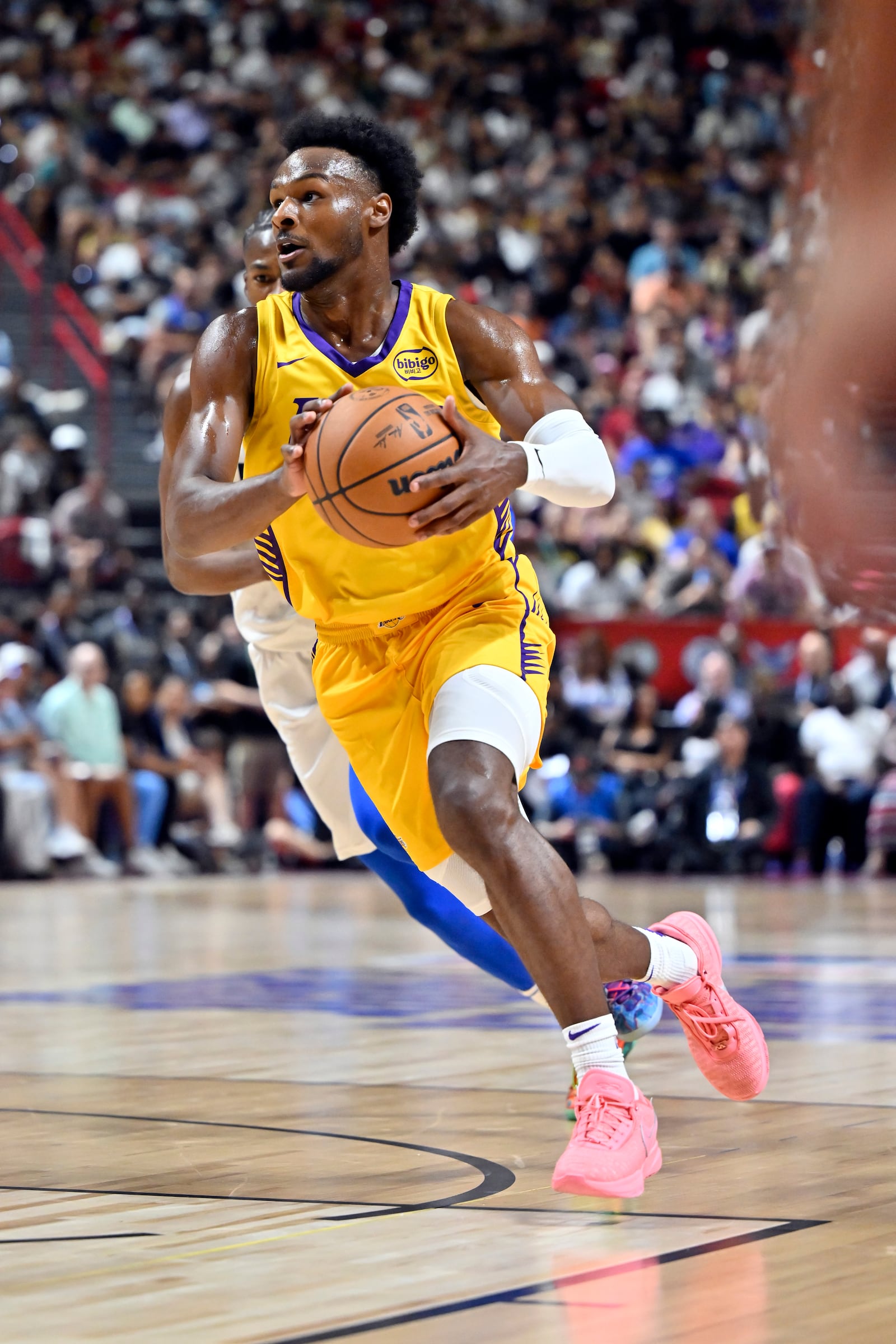 Los Angeles Lakers guard Bronny James (9) drives the ball against the Dallas Mavericks during the first half of an NBA summer league basketball game Thursday, July 10, 2025, in Las Vegas. (AP Photo/David Becker)