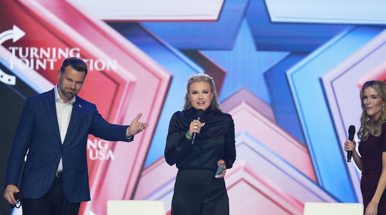 Erika Kirk, center, speaks as Jack Posobiec, left, and Megyn Kelly look on during Turning Point USA's AmericaFest 2025, Friday, Dec. 19, 2025, in Phoenix. (AP Photo/Ross D. Franklin)