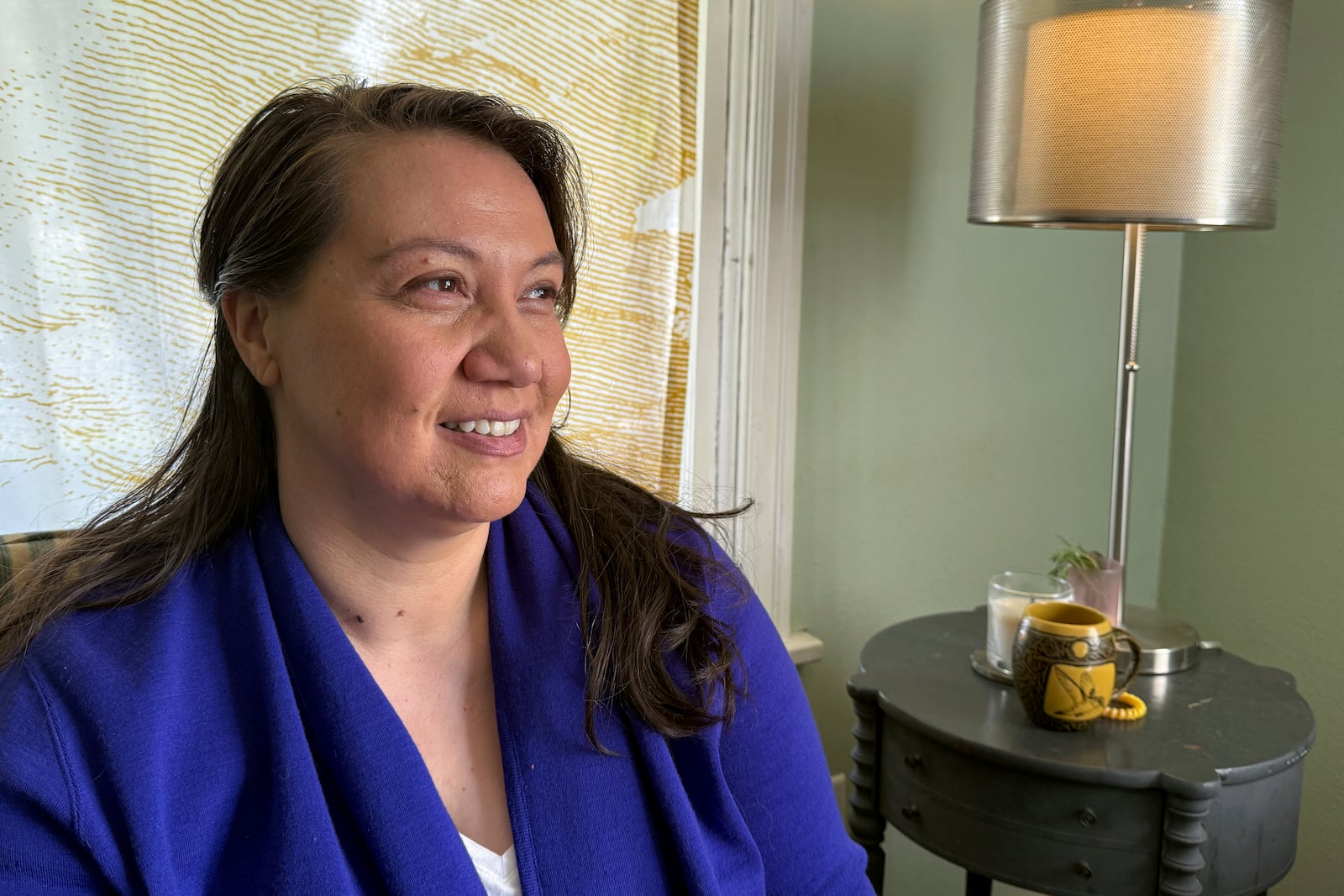 Siniva Bennett, board chair of the Samoa Pacific Development Corporation, sits in her home in Portland, Ore., Monday, May 19, 2025. (AP Photo/Claire Rush)
