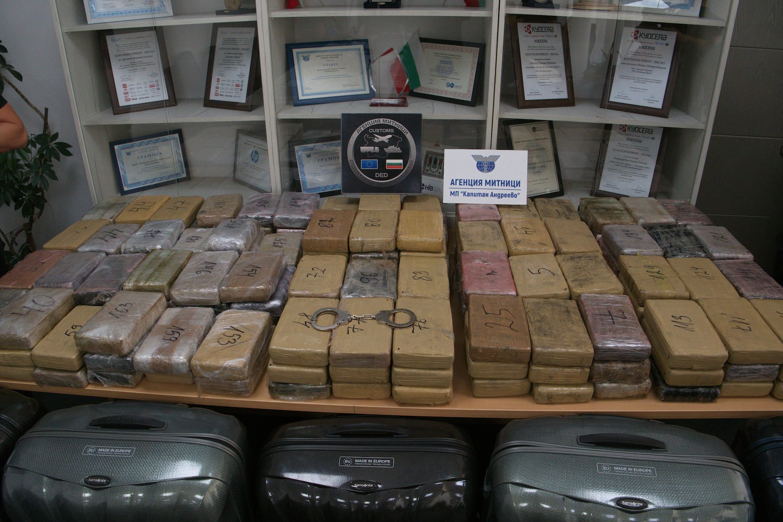 Sealed bags of cocaine which were hidden in suitcases, seen below, and seized by Bulgarian border authorities, are displayed at a border customs' office in Kapitan Andreevo, Bulgaria, Sunday, July 20, 2025. (Bulgarian Interior Ministry via AP)