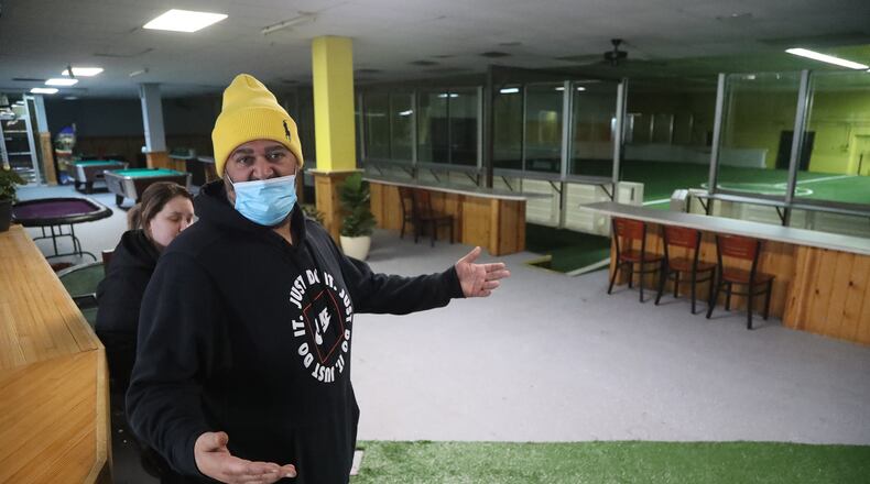 Gyasi Jones, owner of the Shamrock Recreation Center, talks about how the free Thanksgiving dinner will be set up in the rec center Tuesday. BILL LACKEY/STAFF