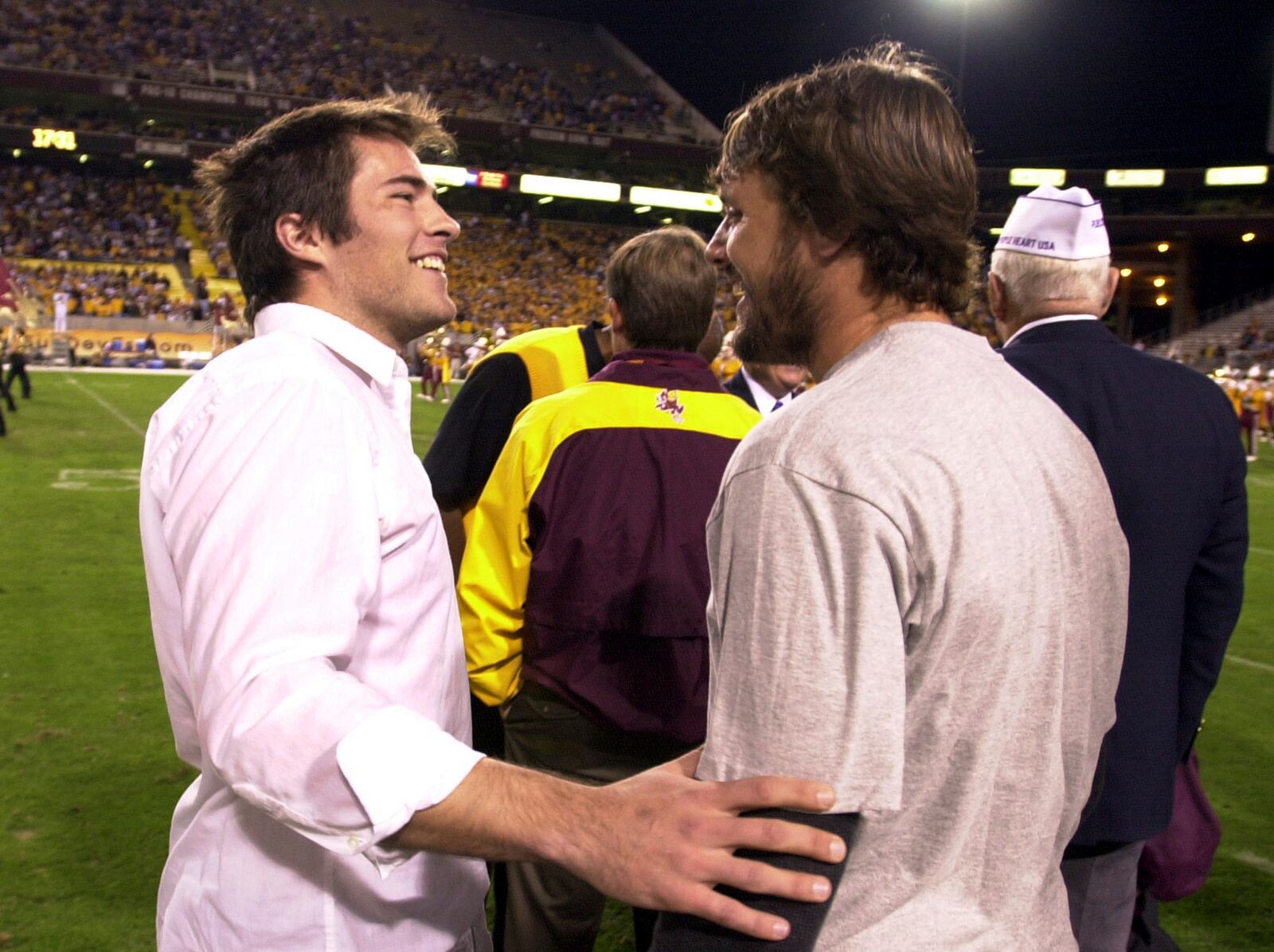 FILE - Richard Tillman, left, the brother of former Arizona State player Pat Tillman, greets one of his brother's former teammates Jake Plummer, right, prior to a ceremony retiring Pat's jersey during halftime of the Washington State and Arizona State game, Nov. 13, 2004, in Tempe, Ariz. (AP Photo/Paul Connors, File)