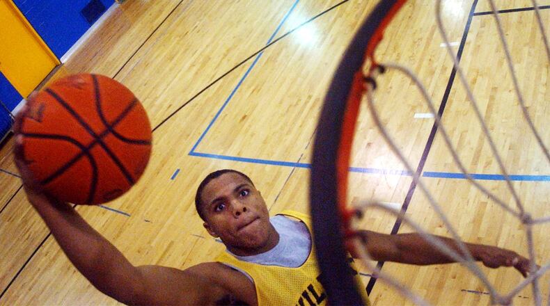 December 9, 2004 News-Sun/Teesha McClam SLUG:snsNateMillerA120904tm.JPG South’s Nate Miller goes for slam dunk during practice at South High School.