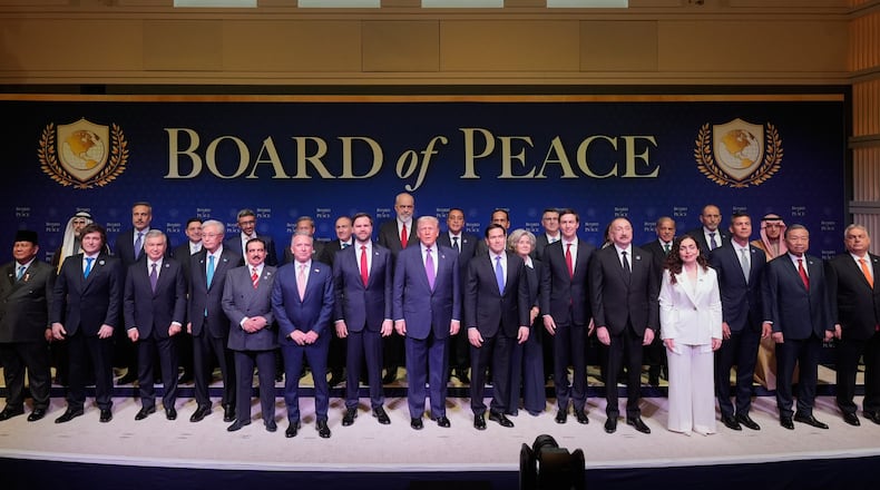 President Donald Trump stands with other World leaders before a Board of Peace meeting at the U.S. Institute of Peace, Thursday, Feb. 19, 2026, in Washington. (AP Photo/Mark Schiefelbein)