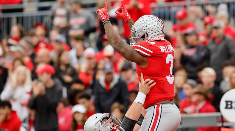 Ohio State running back Miyan Williams, top, celebrates his touchdown against Rutgers with teammate offensive lineman Matthew Jones during the first half of an NCAA college football game, Saturday, Oct. 1, 2022, in Columbus, Ohio. (AP Photo/Jay LaPrete)