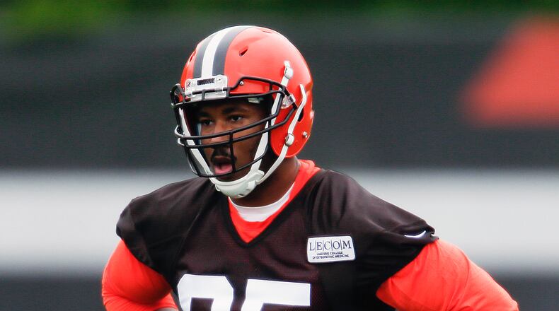 FILE - In this May 12, 2017, file photo, Cleveland Browns’ Myles Garrett listens to his coaches during NFL football rookie minicamp, in Berea, Ohio. Myles Garrett limped off the field Wednesday, June 14, 2017 a scary sight for the Cleveland Browns. The No. 1 overall draft pick sustained an injury to his left foot late in practice while rushing quarterback Brock Osweiler during a two-minute drill. (AP Photo/Ron Schwane, File)