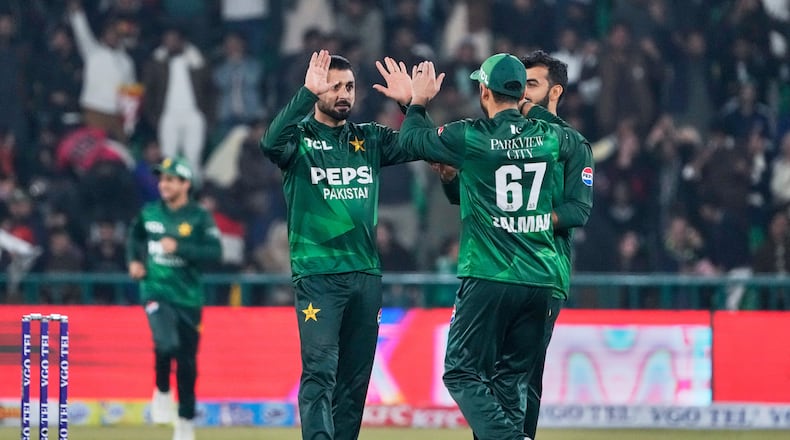 Pakistan's Abrar Ahmed, left, celebrates with teammates after the dismissal of Australia's Cooper Connolly during the first T20 cricket match between Pakistan and Australia, in Lahore, Pakistan, Thursday, Jan. 29, 2026. (AP Photo/K.M. Chaudary)