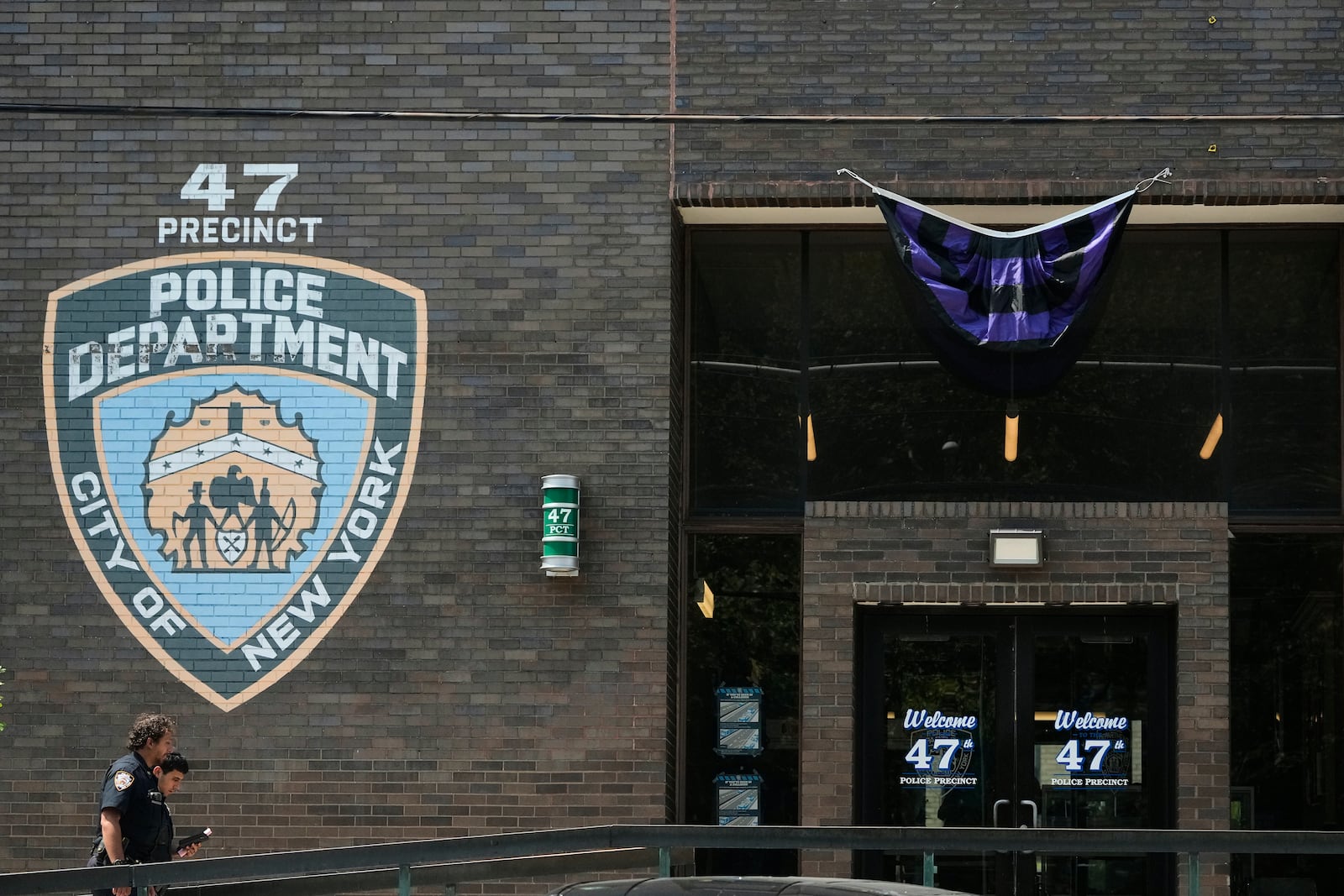 New York Police officers arrive at the NYPD 47th Precinct where NYPD officer Didarul Islam, who was killed Monday, served, in the Bronx borough of New York, Tuesday, July 29, 2025. (AP Photo/Seth Wenig)