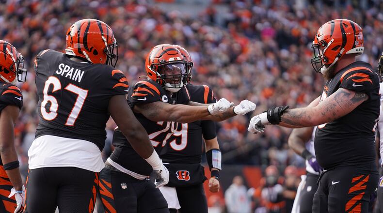 Cincinnati Bengals' Joe Mixon (28) celebrates after scoring a touchdown during the first half of an NFL football game against the Baltimore Ravens, Sunday, Dec. 26, 2021, in Cincinnati. (AP Photo/Jeff Dean)