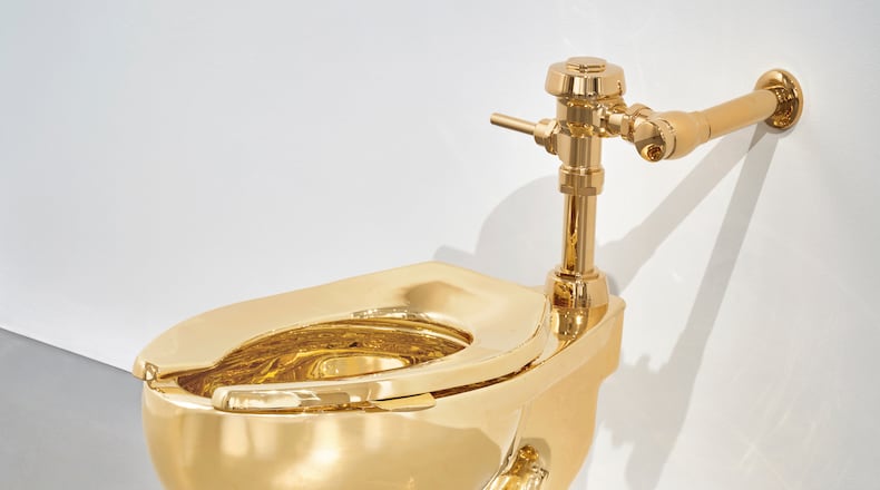 Sotheby’s has announced it will auction a solid gold toilet, a sculpture by Italian artist Maurizio Cattelan called “America.” The auction is set for Nov. 18 in New York. (Sotheby via AP)