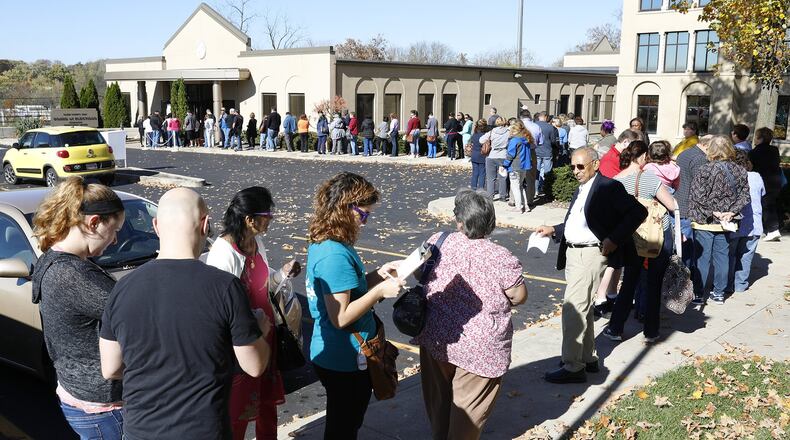A line of voters stretched out the door and around the parking lot of the Clark County Board of Elections as people wait for over an hour to cast their vote on Nov. 7, 2016. BILL LACKEY / STAFF